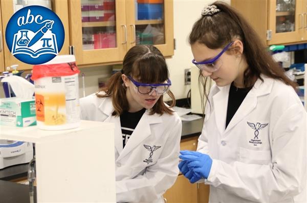 Two students doing science work